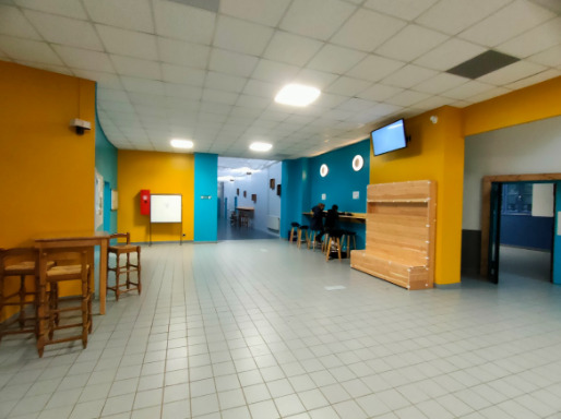 photo de l'aménagement du hall du lycée la Martinière Diderot avec un pilier connecté et permettant de s'asseoir et des couleurs chaleureuses et accueillantes